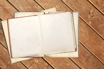 Old open books with empty pages on wooden boards. Opened vintage book with blank page on wood plank