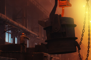 Foundry worker in metallurgy plant after iron cast, heavy industry.