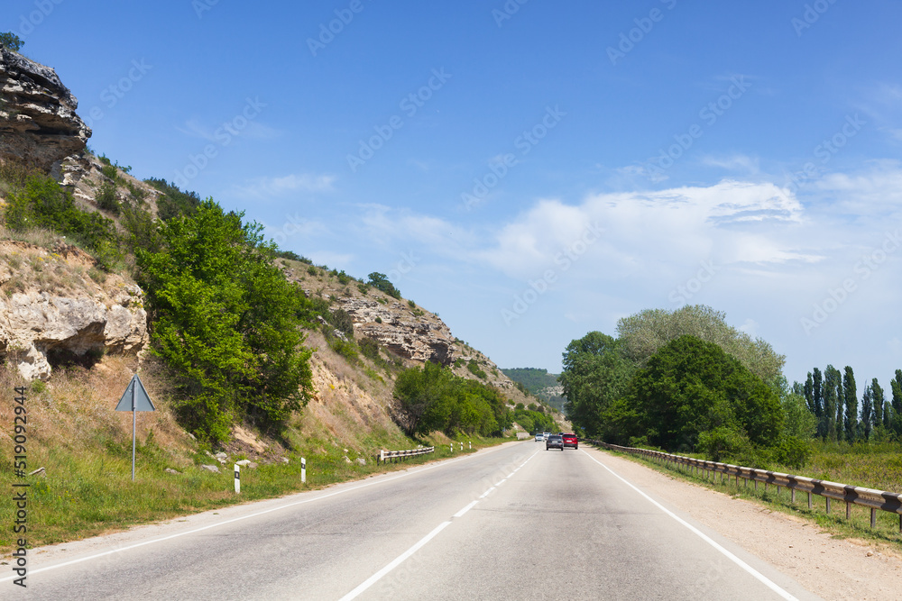 Wall mural summer landscape with cars on a mountain highway