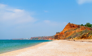 Lyubimovka beach coastal view with red cliffs. Crimea