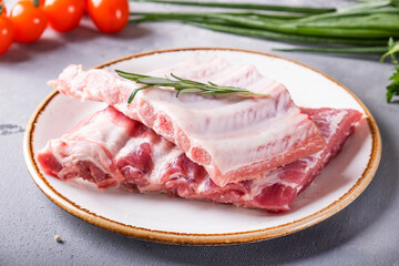Raw pork ribs on a plate.