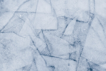 frozen lake Baikal with ice floes and cracks. patterns of Baikal ice. blue textured ice background. copy space.