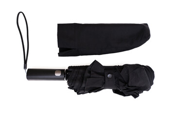 Folded black umbrella with cover isolated on white