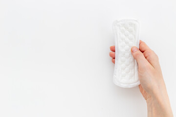 White pad in female hand. Menstruation period and daily hygiene concept © 9dreamstudio