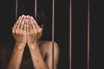 male inmate in prison use both hands to cover your face.concept for...