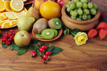 A variety of fresh ripe fruits on a wooden table.