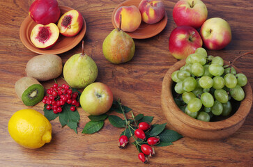 A variety of fresh ripe fruits on a wooden table.