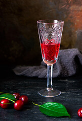 Homemade cherry alcohol drink liquor with fresh cherry berries. Homemade liqueurs