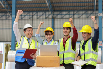 Group of technician engineer and businessman in protective uniform standing and raising hands with computer celebrate successful together or completed deal commitment at industry manufacturing factory