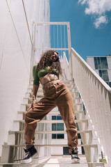 Young female dancer urban portrait on stairs of a modern building
