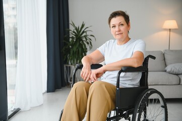 Obraz na płótnie Canvas middle aged woman sitting on wheelchair