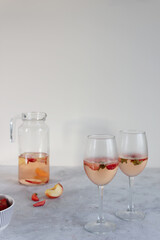 Rose wine sangria with strawberry in the glasses on the gray background