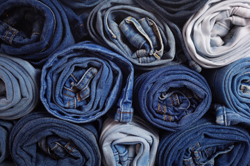 Blue jeans denim heap background. Jeans fabric heap as material surface