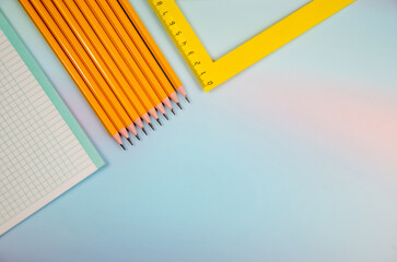 Naklejka premium School background. Pencils, notebook sheet, ruler on pale blue background. Copy, text space. Back to School concept, top view. School office supplies. Collection of school supplies on blue background