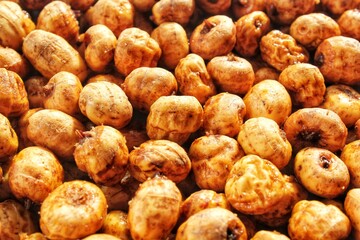 Close-up of chufa, tigernut, earth almond preparing for traditional typical tasty homemade cold fresh drink horchata from Valencia, Spain. Healthy organic food concept. Tiger nut for flour and milk