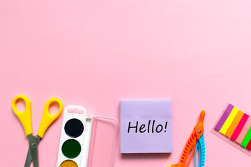 Back to school background. School accessories on a pink background.