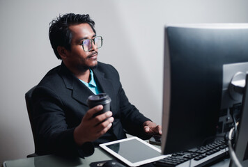 The concept works through computer data. young businessman working in modern office man using contemporary laptop at night

