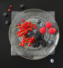 strawberries and blueberries, blackberries and red currant in a bowl