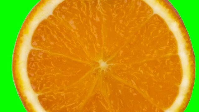 half orange or mandarin slice scaling in rotation on chroma key background, graphic seamless loop animation