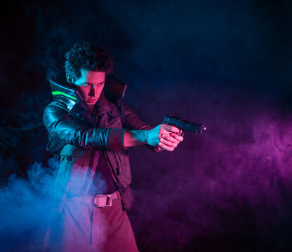 A guy in a cyberpunk image, aiming a gun at someone. a futuristic character. A young man in neon lighting on a black background