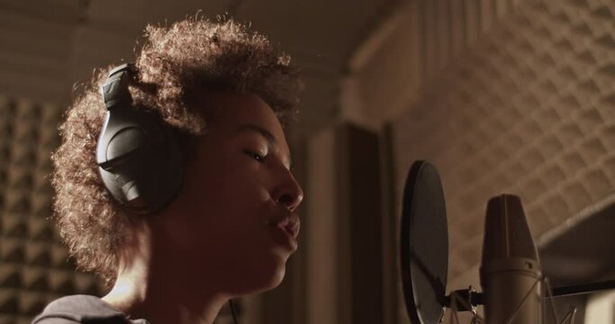 Black singer rapping in studio