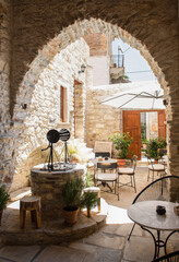 Beautiful patio with old well in Chalky, in Naxos island, Greece. Typical greek decoration. 