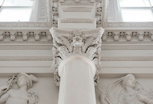 Elements of architectural decorations of buildings, columns and tops, old gypsum stucco molding