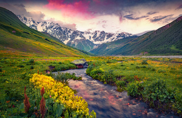Fantastic summer sunset in Caucasus mountains. Calm evening view of main Caucasus ridge, Ushguli...