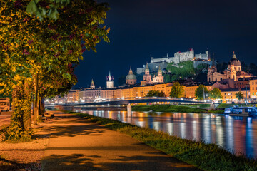 Fototapeta premium Wonderful summer view of Old town of Salzburg. Illuminated cityscape of Salzburg with Hohensalzburg Castle on background, Austria, Europe. Traveling concept background.