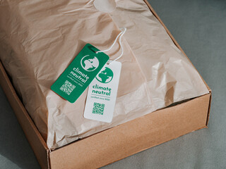 Carbon neutral product in craft corrugated box with label Climate neutral. Carbon neutral label...