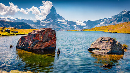 Huge boulders on Stellisee lake. Colorful summer scene with Matterhorn peak on background. Splendid...