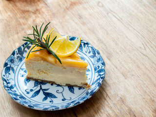 Orange cake topped with orange marmalade, sliced ​​orange and rosemary leaves.Placed in a plate. Coffee time. Eat with coffee.