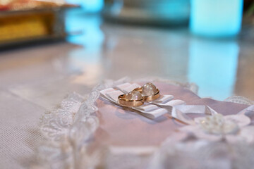 Gold wedding rings on a stand. Wedding.