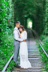 guy embraces girl. the girl with a wreath on her head closed her