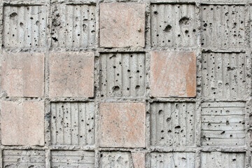 Old collapsed square ceramic tiles on a cement background