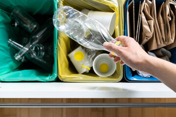 Recycling concept - female sorts of plastic, glass and paper 