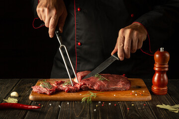Butcher or chef preparing raw fresh beef meat on cutting board before baking or barbecue. Recipe idea for a restaurant or hotel