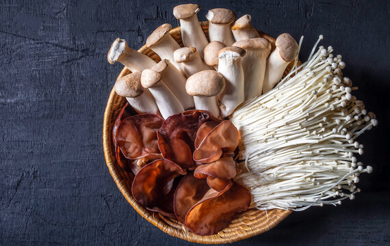 Top View Of Ear Mushroom Or Black Jelly Fungus ,golden Needle Mushroom,Royal Oyster Mushroom In Wooden Basket V