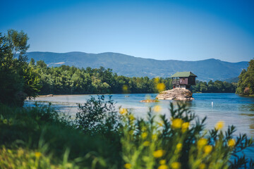 Drina river with famous house on the rock. Summer landscape, travel to Serbia