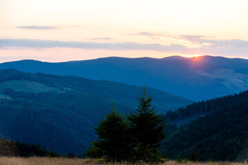 Fototapeta na wymiar Beautiful sunset landscape with mountains and trees
