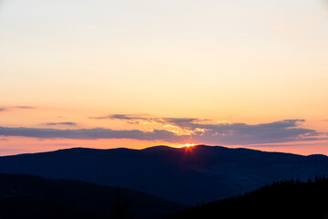 Beautiful sunset landscape with mountains and trees