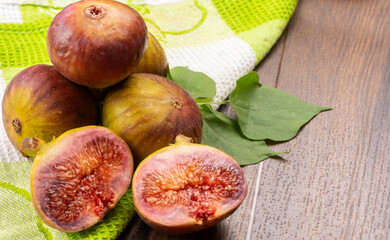 Freshly ripe figs. Healthy Mediterranean fig fruit. Fresh figs on a dark background. Beautiful blue...