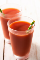 Fresh watermelon juice in glass on white wooden table