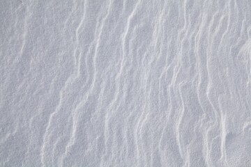Fototapeta na wymiar Winter scene with snow patterns on ground.