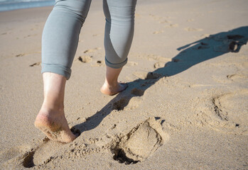 female feet walking on a beautiful secluded beach