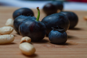 blue berries with some seeds of puffed rice on the bamboo cutting board