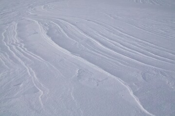 Winter scene with snow patterns on ground in cold winter weather.