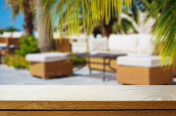 Art Empty wooden table on sunny blurred tropical hotel patio background