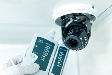 Professional cctv technician is working. A technician checks a CCTV camera.