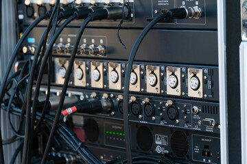 Close up audio snake and stage box with xlr cables and jacks at a live show